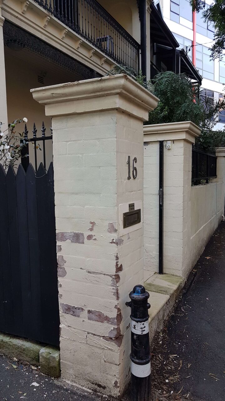 Peeling exterior paint on a coastal property wall