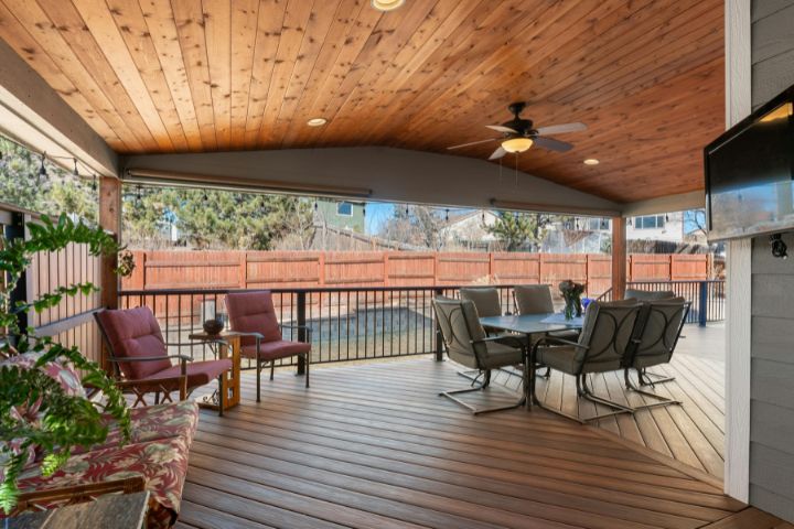 A beautiful deck with chairs and a table.