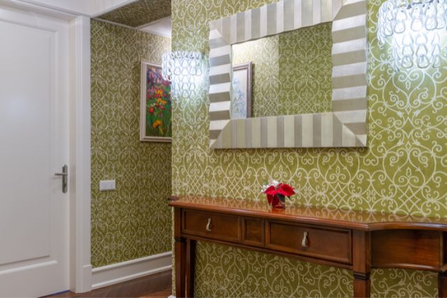 House hallway with patterned wall paper.