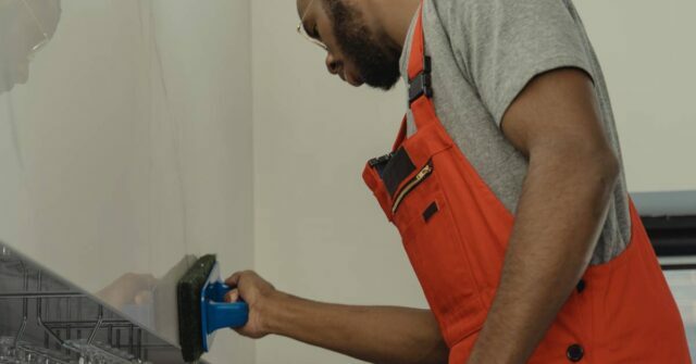 A man thoroughly brushing an interior wall.