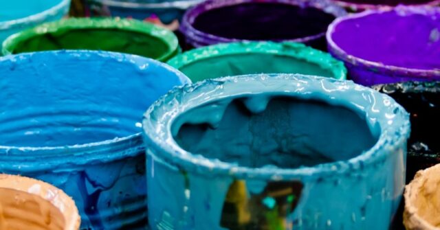 Assorted-color of cheap old paint cans.