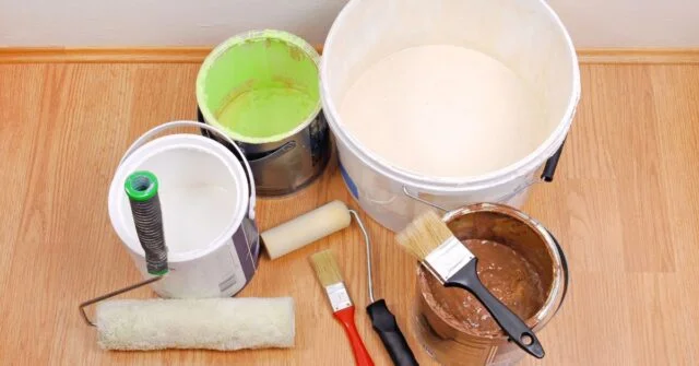 Paint brushes and rollers in a painter's toolkit.