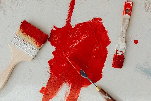 Red paint with splattered using two small brushes.