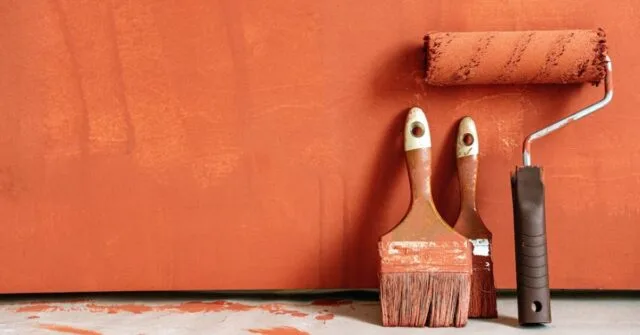 Close-Up Shot of Variety of Paintbrushes with Orange Paint.