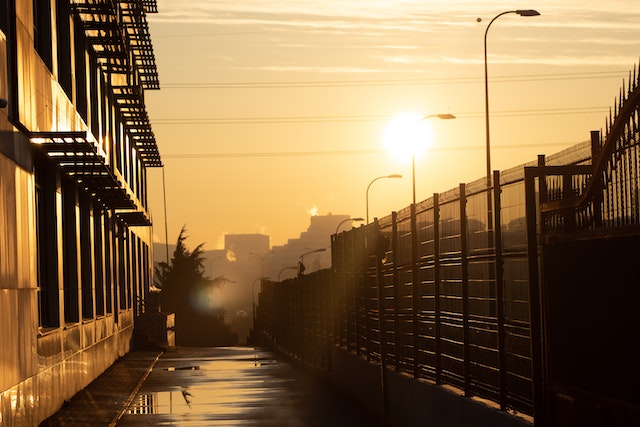 Scorching sun over wet pavement after rain.