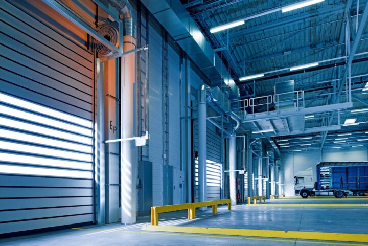 An empty warehouse with a parked truck.