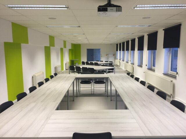 Office meeting room with newly painted green accent walls.