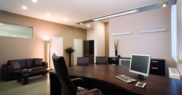 Interior of freshly painted office showing large desk.