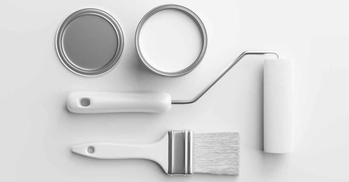 Two cans of paint, white and grey, also a white paint brush and roller.