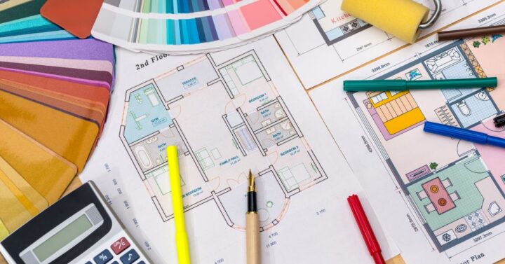 Floor plans, colour swatches, calculator and pens all laid out in preparation of project.