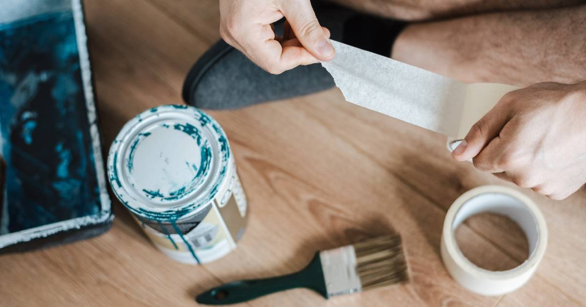 A man preparing tools before starting a painting project.