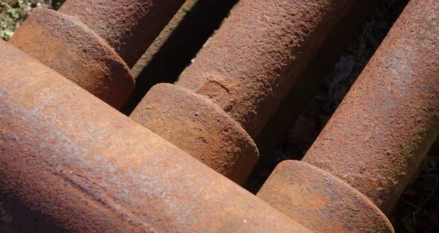 Severely rusted pipes somewhere on a house