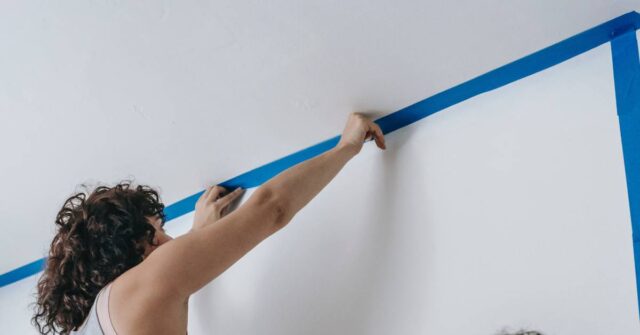 Preparing to paint the house interior by using a painter's tape.